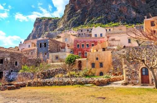 Monemvasia street panorama with old houses, trees in ancient town, Peloponnese, Greece