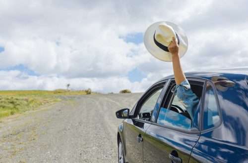 A traveler sticks his hand out of a rental car, to indicate his enjoyment of the trip in Greece.