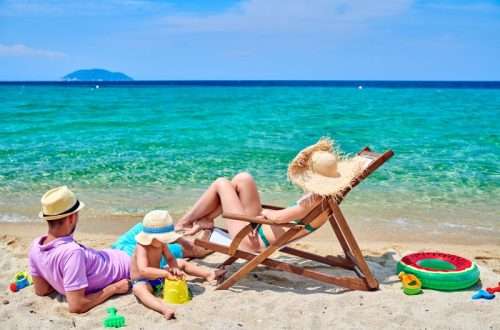 Family on beach, young couple with three year old boy. Sithonia, Greece