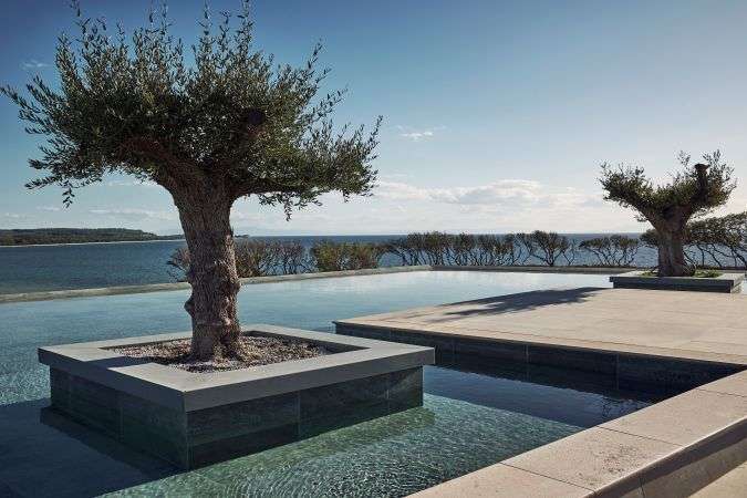 מבנה המלון Zelia Halkidiki הבנוי על צלע גבעה ירוקה ומשקיף על המפרץ