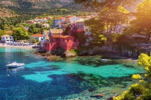 Assos village in Kefalonia, Greece. Turquoise colored bay in Mediterranean sea with beautiful colorful houses in Assos village in Kefalonia, Greece, Ionian island, Cephalonia, Assos village.