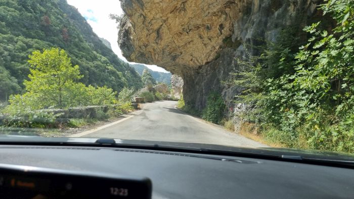 נהיגה מתחת לסלע בכביש 82 בפלופונס יוון דרך נופית בתוך קניון