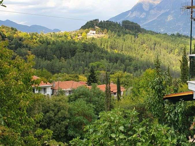 The lush green landscapes and impressive mountains of Pramanta village, Tzoumerka, Northern Greece.