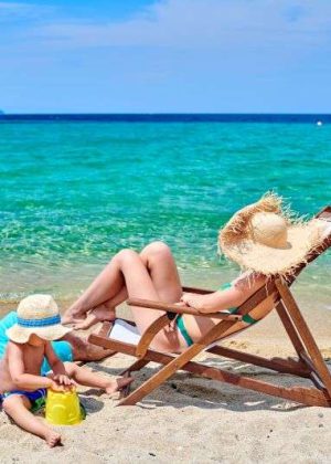 Family on beach, young couple with three year old boy. Sithonia, Greece